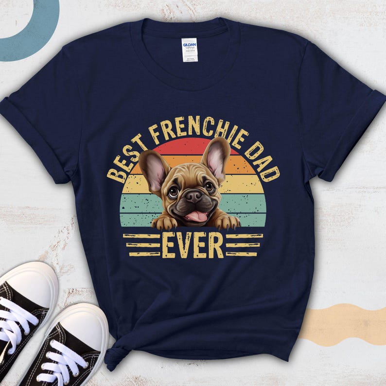 May include: Navy blue t-shirt with a vintage-style graphic of a French bulldog. The graphic says "Best Frenchie Dad Ever".