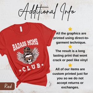 May include: Red t-shirt with a skull graphic and the text "BADASS MOMS *CLUB*" printed on it. The text is in a white font with a black outline. The skull is wearing a bandana with leopard print and a bun. The skull has angel wings.