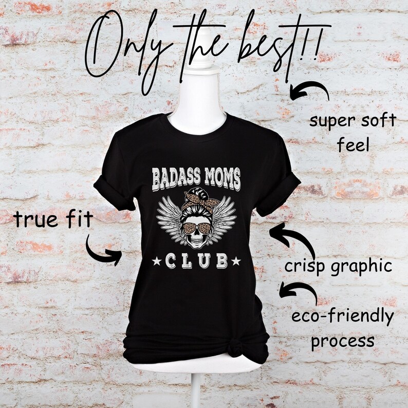 May include: Black t-shirt with a white graphic of a skull wearing sunglasses and a bandana with the text "BADASS MOMS *CLUB*" printed on it.