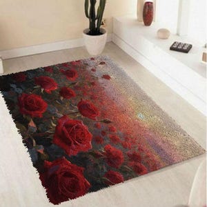 May include: A rectangular area rug featuring a detailed print of vibrant red roses scattered across a textured background that transitions from deep dark tones on the left to a lighter, golden-hued gradient on the right side of the rug.