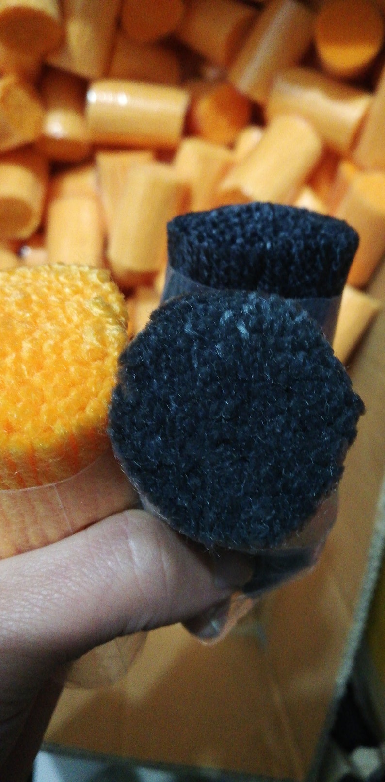 May include: Two spools of yarn, one orange and one black. The spools are wrapped in clear plastic.