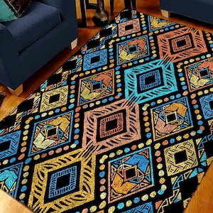 May include: A black and white rug with a geometric pattern in shades of blue, yellow, orange, and pink. The pattern features a series of diamonds and squares.