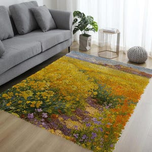 May include: A rectangular area rug featuring a vibrant field of yellow flowers with hints of orange and purple. The rug's design resembles a painting, with a blue sky in the background. The rug is placed on a light-colored wooden floor.