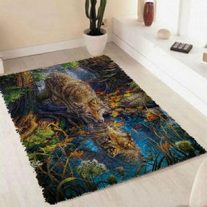 May include: A rug with a colorful design featuring two wolves drinking from a stream in a forest setting. The wolves are brown and white, and the forest is filled with green trees, blue water, and yellow leaves.