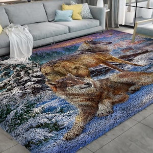 May include: A blue, white, and brown rug with a snowy forest scene and two wolves. The wolves are brown and white with black noses and eyes. The rug is made of a soft, plush material.