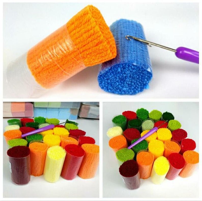 May include: Assortment of colourful yarn spools in various shades of red, orange, yellow, green, and blue. The yarn is wrapped around cardboard tubes and is ready for use in craft projects.