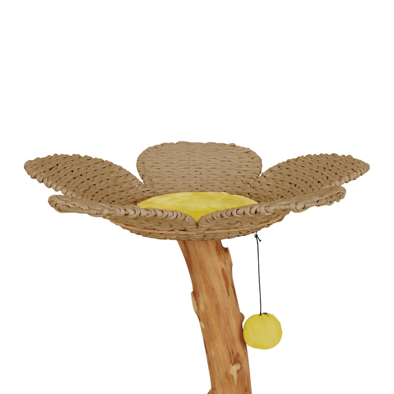 May include: A cat tree shaped like a flower with a brown wicker base and a yellow cushion. The tree has a natural wood trunk and a dangling yellow toy.