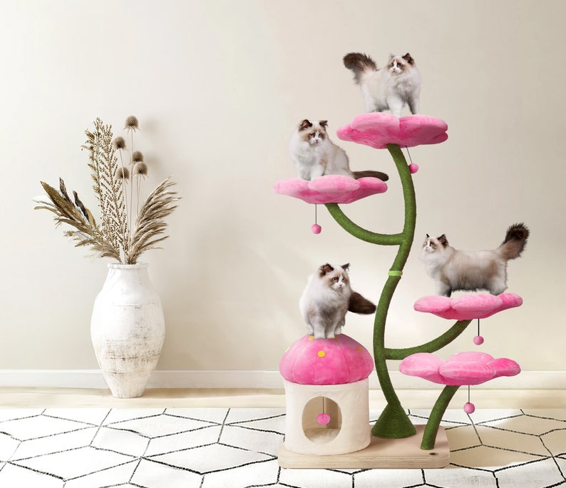 May include: Pink cat tree with multiple platforms shaped like flowers. The cat tree has a pink mushroom-shaped base with a hole in the middle. Five cats are on the cat tree.