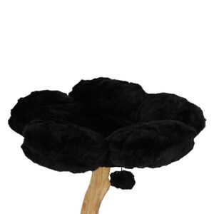 May include: A black cat tree with a flower-shaped bed made of plush material. The bed sits atop a natural-colored wooden post. A small, dangling pom-pom is attached below the bed.