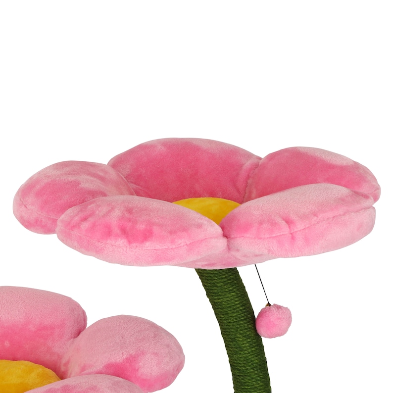 May include: Pink cat scratching post shaped like a flower with a yellow center. The post is covered in sisal rope and has a dangling toy.