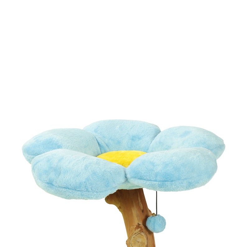 May include: A blue and yellow flower-shaped cat bed with a dangling toy attached to the base. The bed is made of soft plush fabric and is attached to a wooden post.