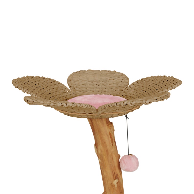 May include: A cat tree shaped like a flower with a pink cushion and a dangling pink toy. The base of the tree is a natural wood log.
