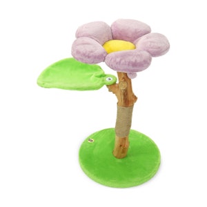 May include: A pink flower-shaped cat scratching post with a green leaf-shaped platform and a green base. The post is wrapped in sisal rope.