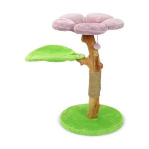 May include: A pink flower-shaped cat bed sits atop a natural wood cat tree with a green leaf-shaped platform. The cat tree has a sisal-wrapped post and a green base.