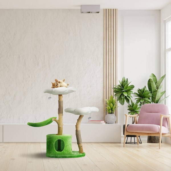 May include: A green cat tree with a white cloud-shaped platform, a green scratching post, and a green and white cat bed. A cat is lying on the top platform. The cat tree is in a room with a pink armchair and plants.
