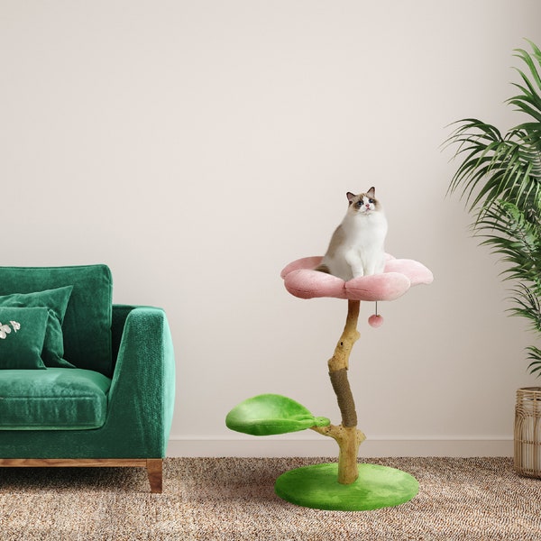 May include: A pink and green cat tree shaped like a flower with a cat sitting on the top platform. The cat tree has a sisal-covered post and a dangling toy.