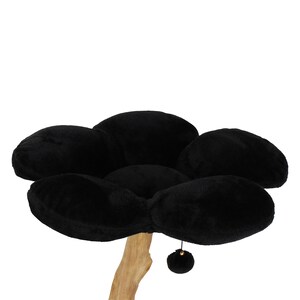 May include: Black cat tree with a flower-shaped bed and a dangling toy. The bed is made of soft, plush fabric and the tree is made of natural wood.