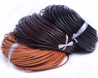 May include: Three bundles of leather cord in shades of brown and black, tied with clear plastic and white ribbon. The cords are tightly coiled, with a smooth, glossy finish, and are ready for crafting projects.