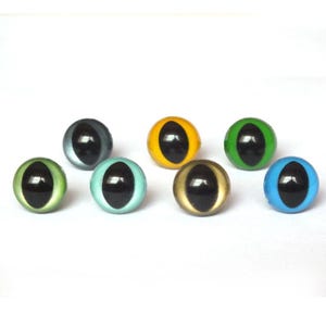 May include: A selection of seven glass eye cabochons in assorted colours, such as green, blue, yellow, and gold. Each eye has a black pupil and a glossy finish, ideal for crafting and doll making projects.