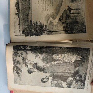 May include: An open antique book with illustrations. One page shows a landscape with a tree and figures near water. The opposite page has a field and text in French. The book's pages are aged and the binding is red.