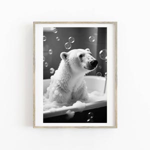 May include: Black and white framed print of a polar bear in a bathtub filled with bubbles. The bear is sitting upright, surrounded by suds and floating bubbles. The image is a close-up, capturing the bear's expression and the details of the bubbles.