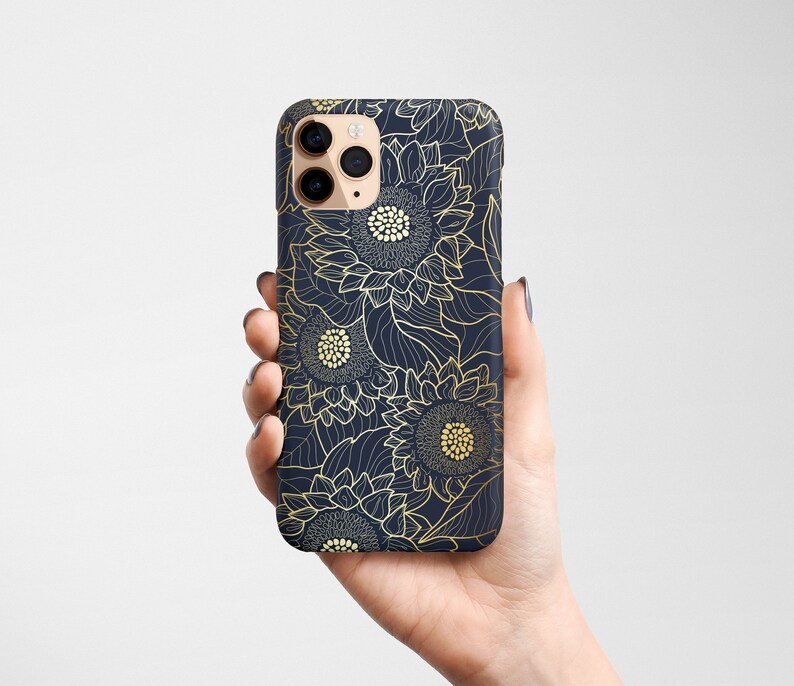 May include: A navy blue phone case with a gold sunflower pattern. The case has a cutout for the camera lens.