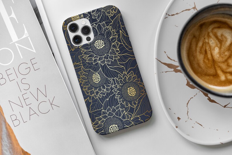 May include: A navy blue phone case with a gold floral design featuring sunflowers. The case has a cutout for the phone's camera.