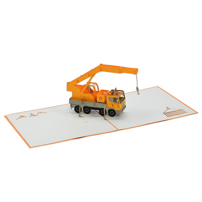 May include: A yellow and gray 3D pop-up card featuring a construction crane. The crane is lifting a small building.
