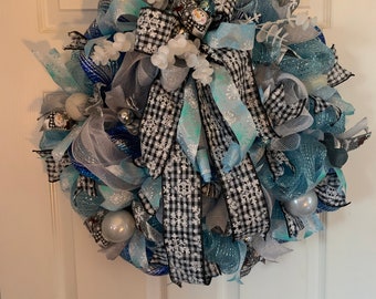 Winter deco mesh wreath with black and white gingham ribbon with snowmen, blue ribbon with snowflakes, silver, white and blue ornaments