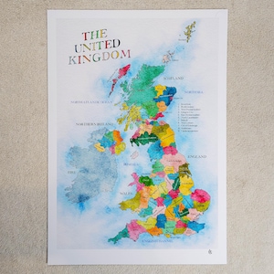 May include: A colorful watercolor map of the United Kingdom, with each region distinguished by a different color. The title "THE UNITED KINGDOM" is at the top in a rainbow of colors. The map includes the North Atlantic Ocean, Northern Ireland, and the English Channel.