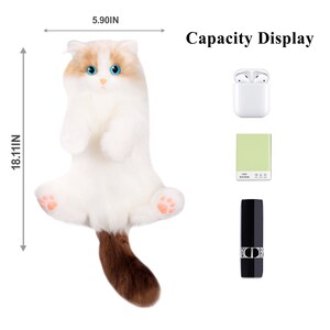May include: A white plush cat toy with brown fur on its tail. The cat is sitting up with its paws in the air. The toy is 5.90 inches wide and 18.11 inches tall. The image shows the toy's capacity by displaying various items that can fit inside, including a pair of wireless earbuds, a small notebook, and a lipstick.