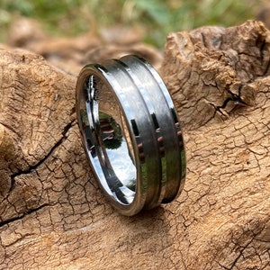 May include: A silver-toned tungsten carbide ring with a brushed finish and three grooves around the band.