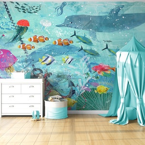 May include: A light blue canopy tent with a white ceiling and a white floor. The tent is set up in a room with a white dresser and a wooden stool. The wall behind the tent has a mural of an underwater scene with fish, jellyfish, and a dolphin.