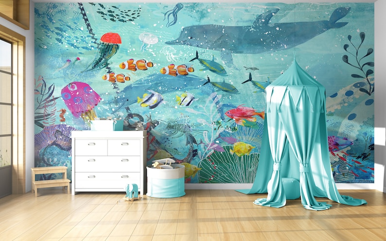 May include: A light blue canopy tent with a white ceiling and a white floor. The tent is set up in a room with a white dresser and a wooden stool. The wall behind the tent has a mural of an underwater scene with fish, jellyfish, and a dolphin.