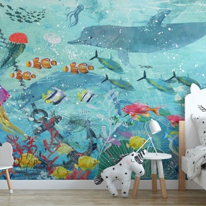 May include: A colorful underwater scene with a dolphin, jellyfish, and various fish. The scene is painted on a wall in a child's bedroom with a white unicorn-shaped headboard and a white stuffed unicorn on the floor.