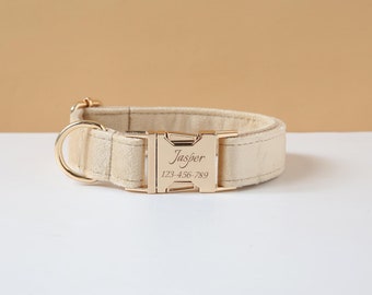 Könnte beinhalten: Ein beigefarbenes Hundehalsband aus Samt mit einer goldenen Schnalle. Die Schnalle ist mit dem Namen "Jasper" und der Telefonnummer "123-456-789" graviert.