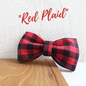 May include: Red and black plaid bow tie. "Red Plaid" text is written above the bow tie.