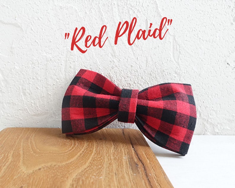 May include: Red and black plaid bow tie. "Red Plaid" text is written above the bow tie.