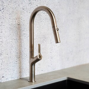 May include: A brushed nickel kitchen faucet with a pull-down sprayer and a single lever handle.