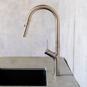 May include: A silver kitchen faucet with a high arc spout and a single lever handle. The faucet is mounted on a gray countertop.