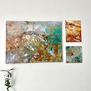 Abstract painted triptych with golden petals and glitter