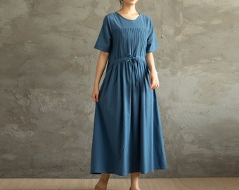May include: A blue, knee-length, casual dress with a round neckline and short sleeves. The dress has a gathered waist with a drawstring tie.
