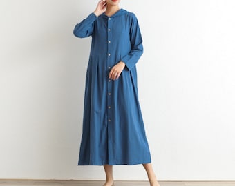 May include: A long, blue hooded dress with a button-up front and a pleated skirt. The dress is made of a lightweight fabric and has a relaxed fit.