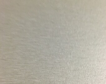May include: A close-up of a light grey textured surface.