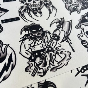 May include: Black and white tattoo flash sheet featuring various traditional tattoo designs. The central image is a muscular figure in a hood holding an axe. Other designs include a skull spider, and a skull with a hat.