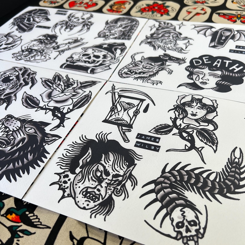 May include: A collection of black and white tattoo flash sheets featuring traditional designs. The sheets display various images, including skulls, roses, a wolf, an hourglass, and a crying woman with the word "DEATH". The artist's name, JAMES WILBY, is printed on some sheets.