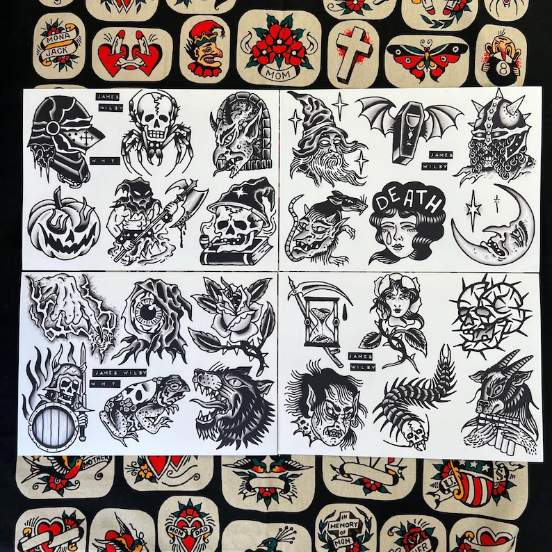 May include: A collection of black and white tattoo flash sheets featuring various traditional tattoo designs. The designs include skulls, demons, roses, and other classic tattoo motifs. The sheets are arranged on a white background.