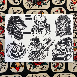 May include: A sheet of tattoo flash art featuring black and white illustrations. Designs include a knight's helmet, a spider-skull, a demon head, a jack-o'-lantern, a grim reaper with an axe, and a skull smoking a pipe. The text "JAMES WILBY WHT" is visible.