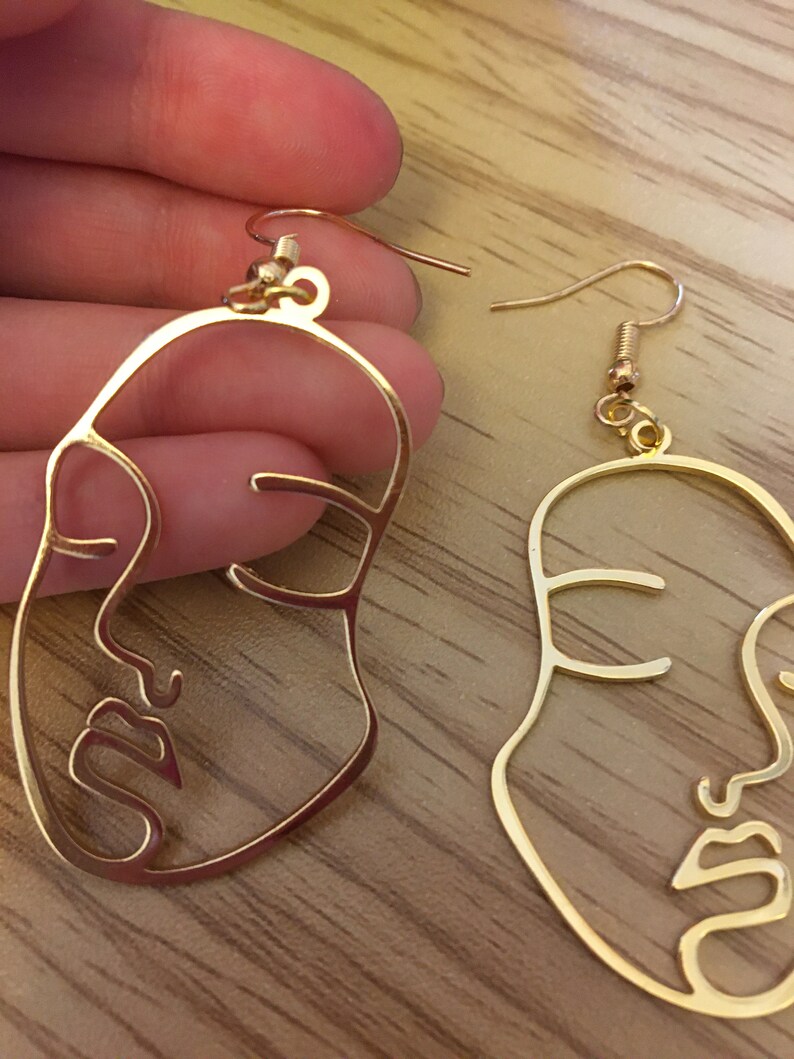 face earrings by Bella