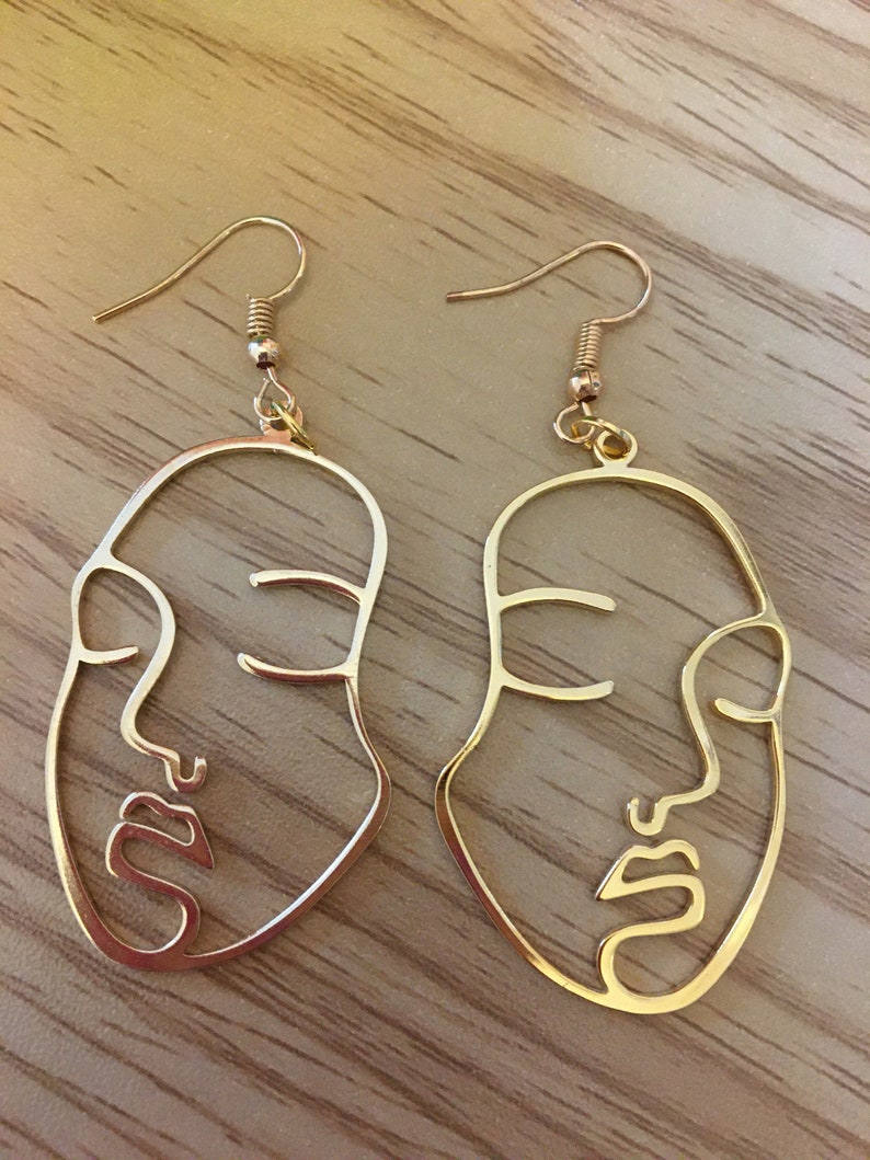 face earrings by Bella